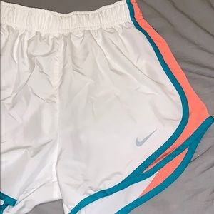 White peach and turquoise Nike Dri-Fit shorts